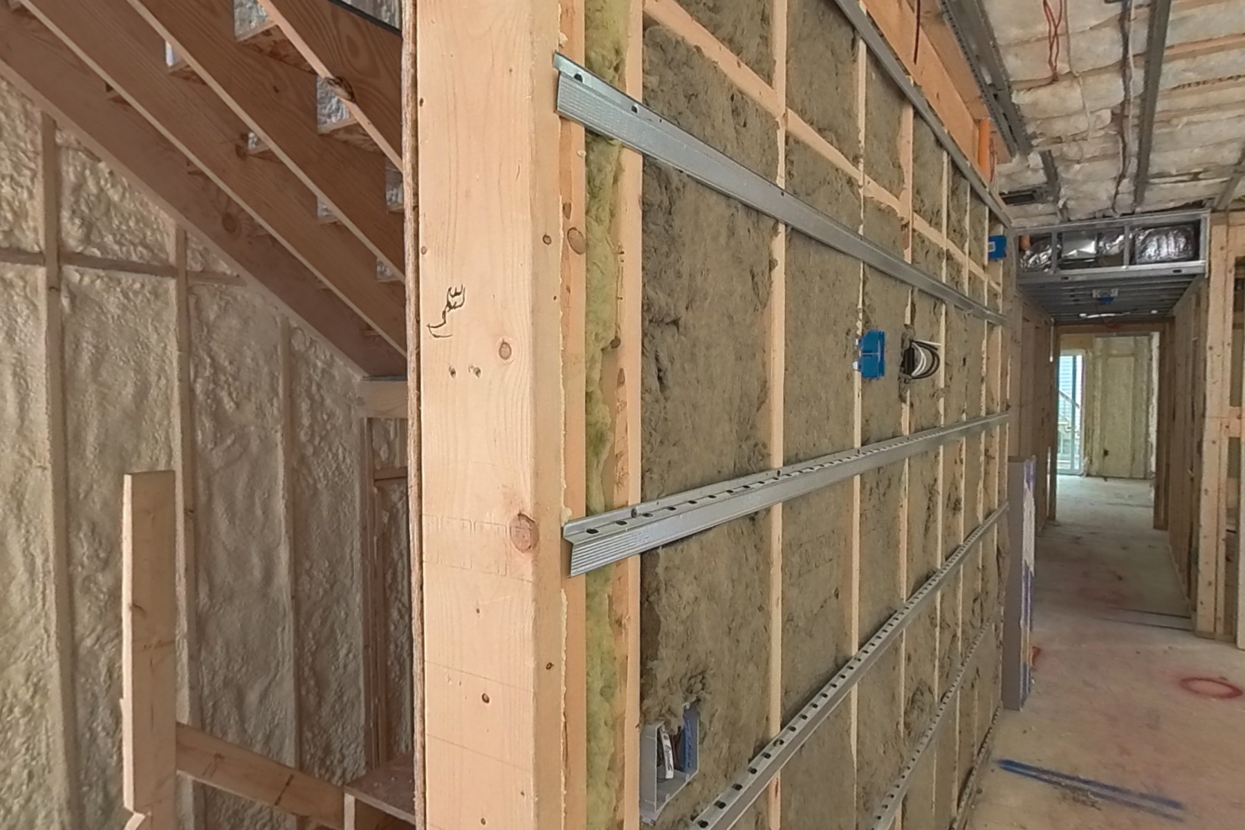 Sound isolation between units: mineral wool and resilient channels installed.